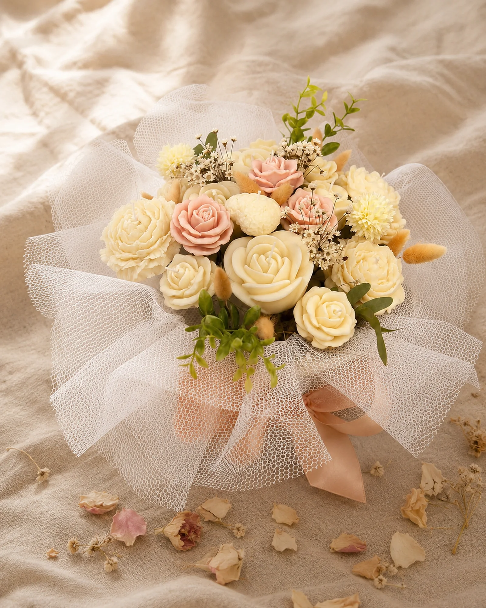 Buquê de velas em tons creme e pêssego com tule branco